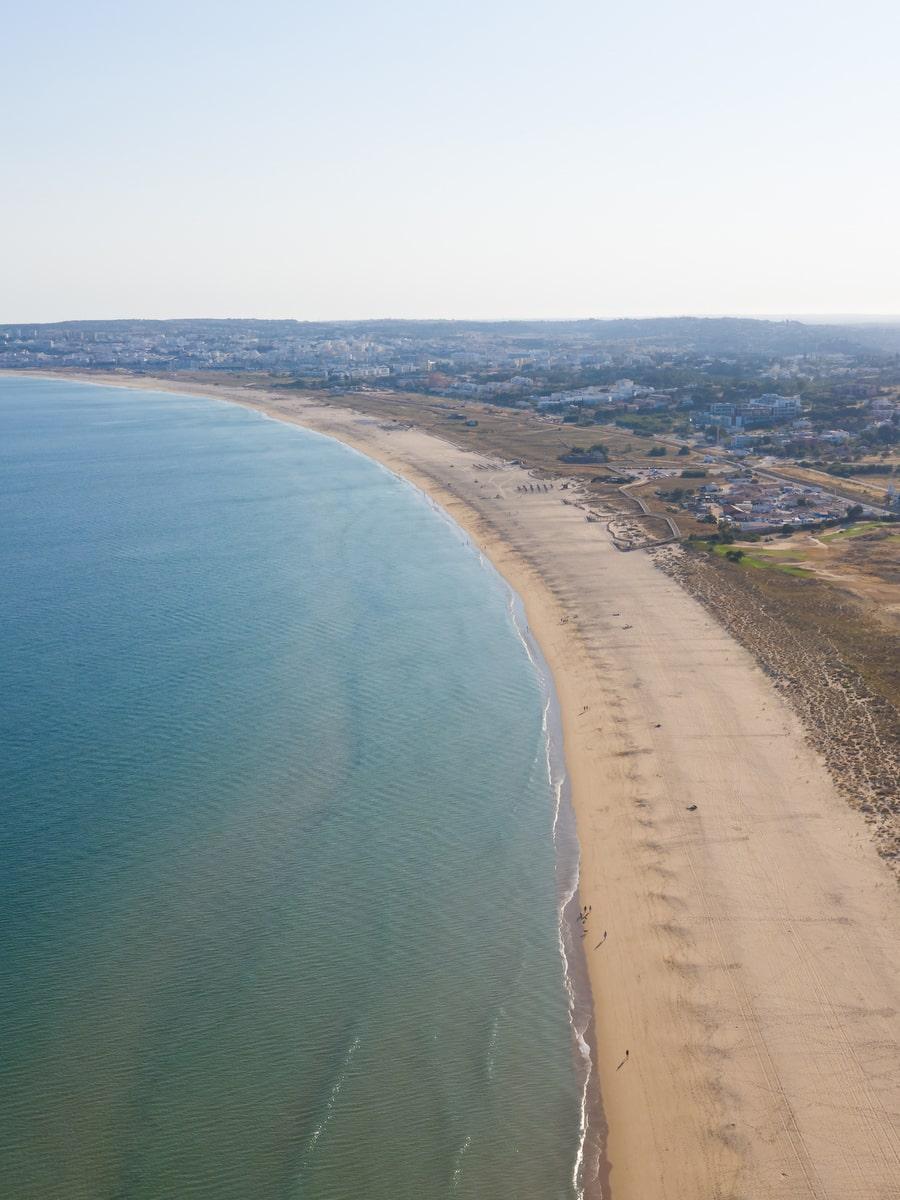 Aerial view of the long sandy Meia Praia beach curving along Lagos Bay