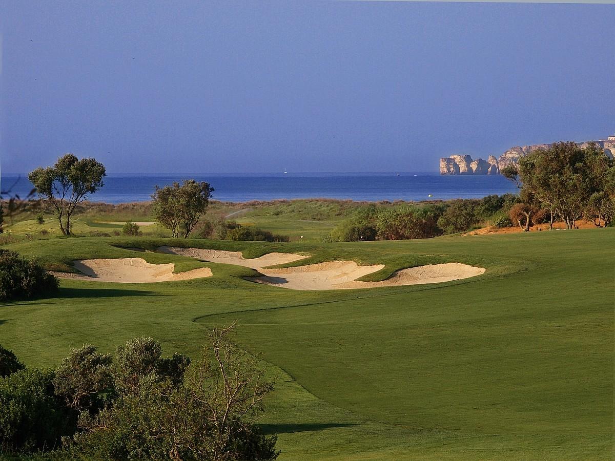 Fairway bunkers on the Palmares course with the Atlantic and coastal rock stacks behind