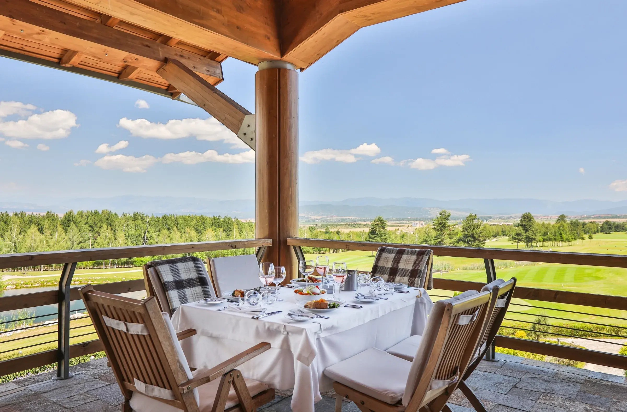 Clubhouse dining terrace overlooking the course and mountains