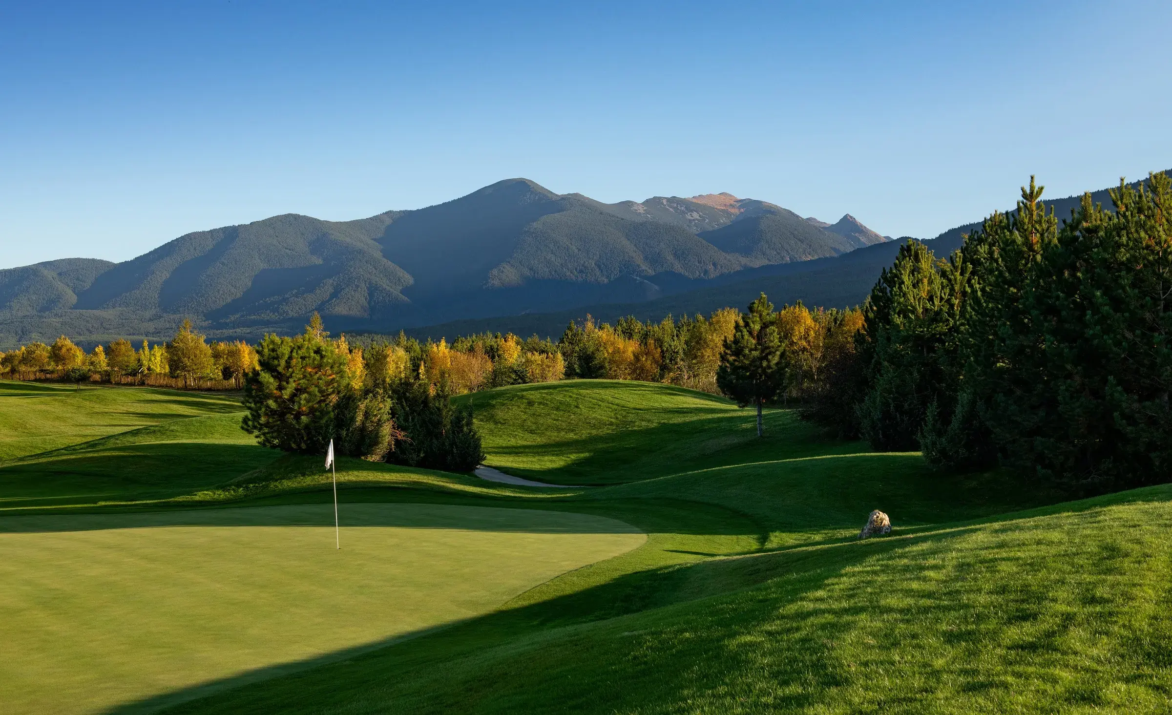 Golf green with a mountain backdrop at Pirin Golf & Country Club