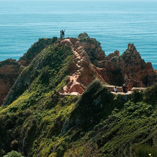 Walkers on a coastal ridge