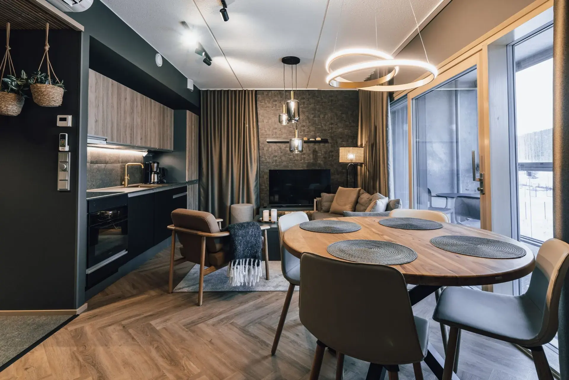 Open-plan suite with a kitchen, dining table and living area
