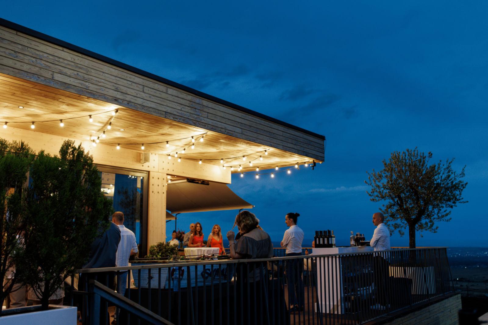Guests dining on the ONO at Hills terrace after sunset