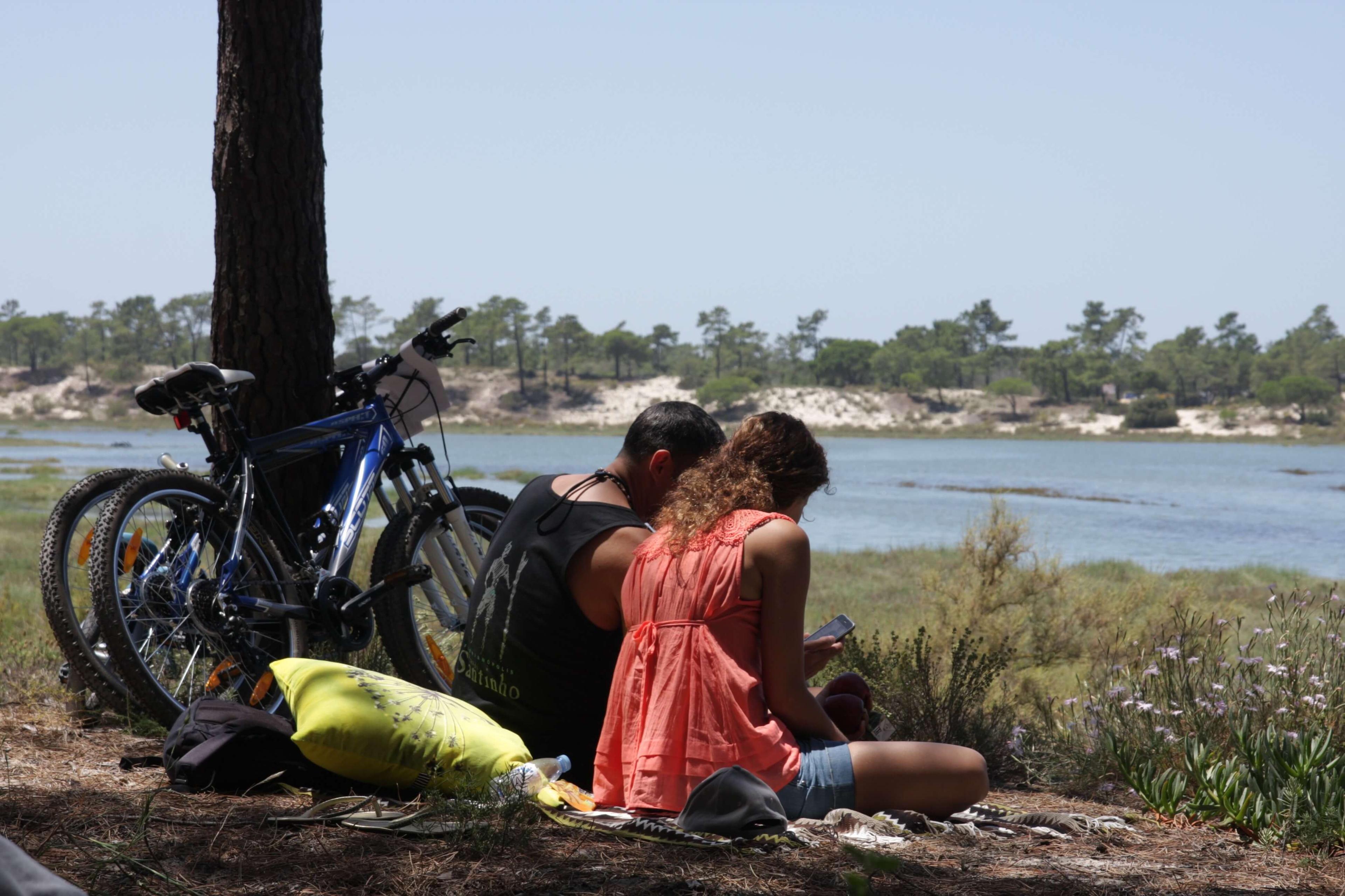 Cyclists taking a break beside the water on the Troia peninsula
