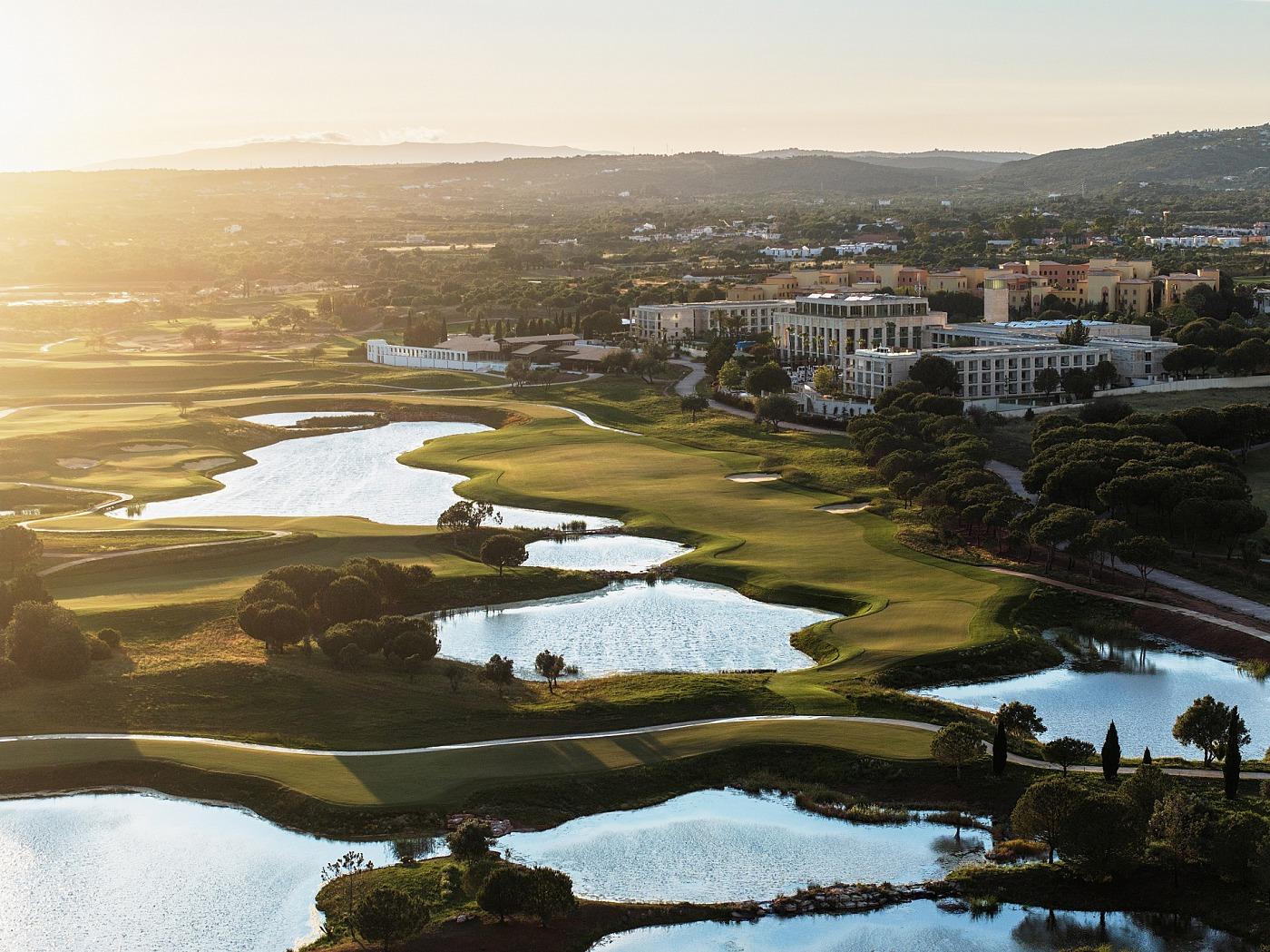 Lakes and fairways beside the clubhouse at The Els Club Vilamoura at sunset
