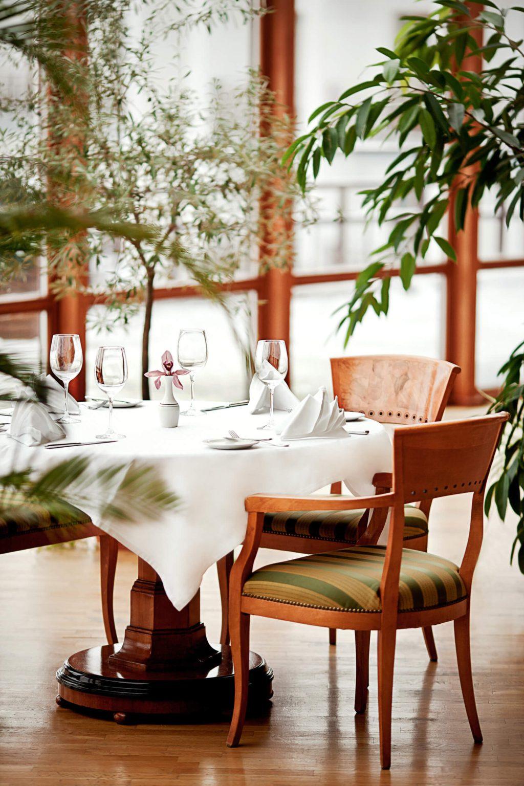 Table laid for dinner among plants in a resort restaurant